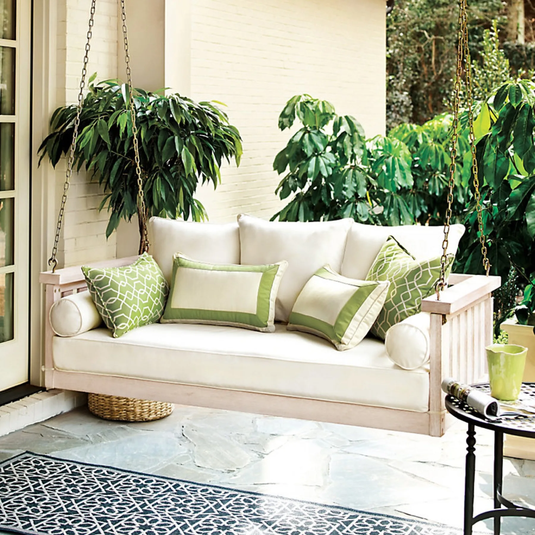 A plush outdoor lounge framed by potted greenery