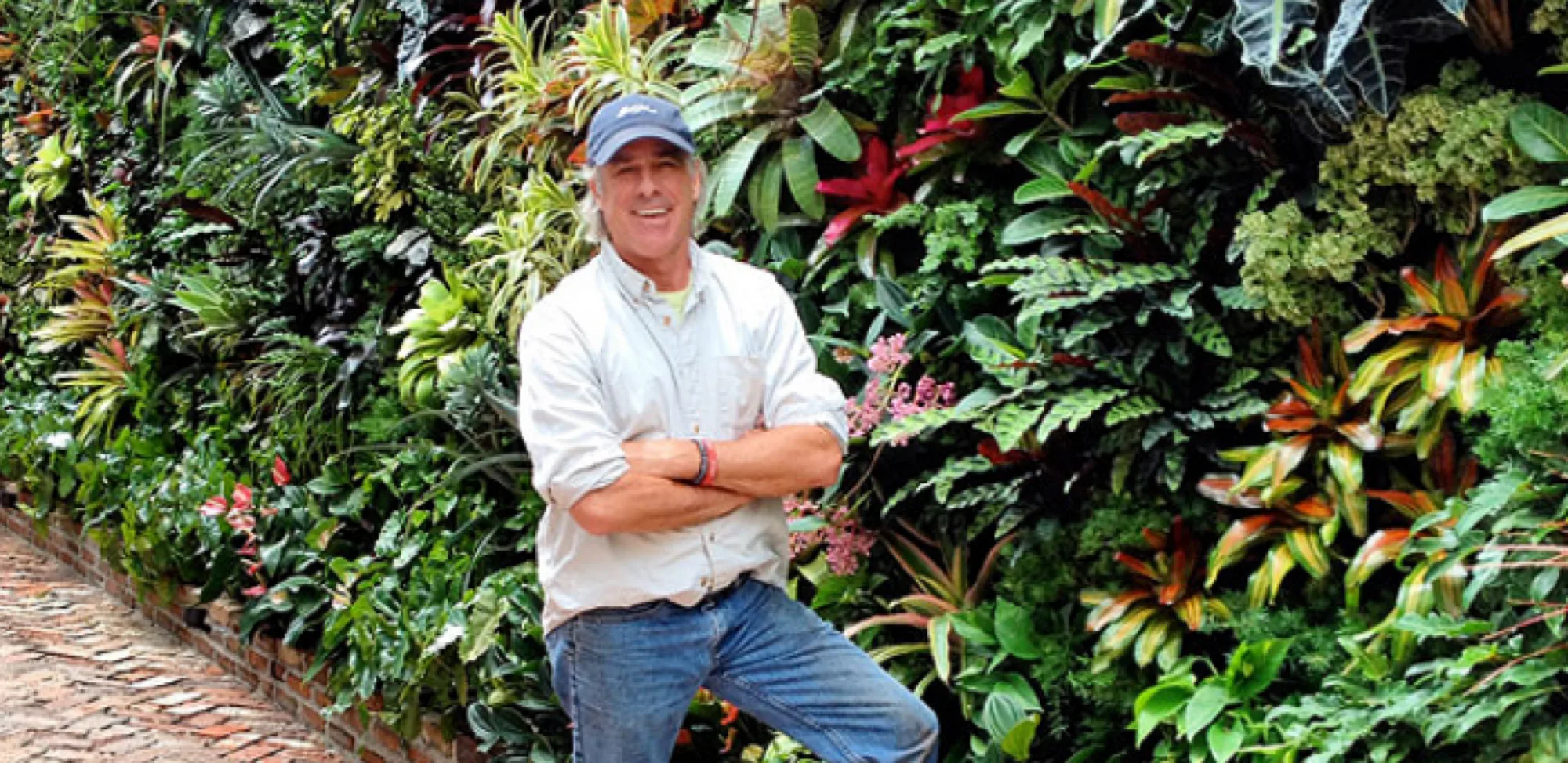 Jeffrey Allis, founder of TruVine Design, beside a living wall